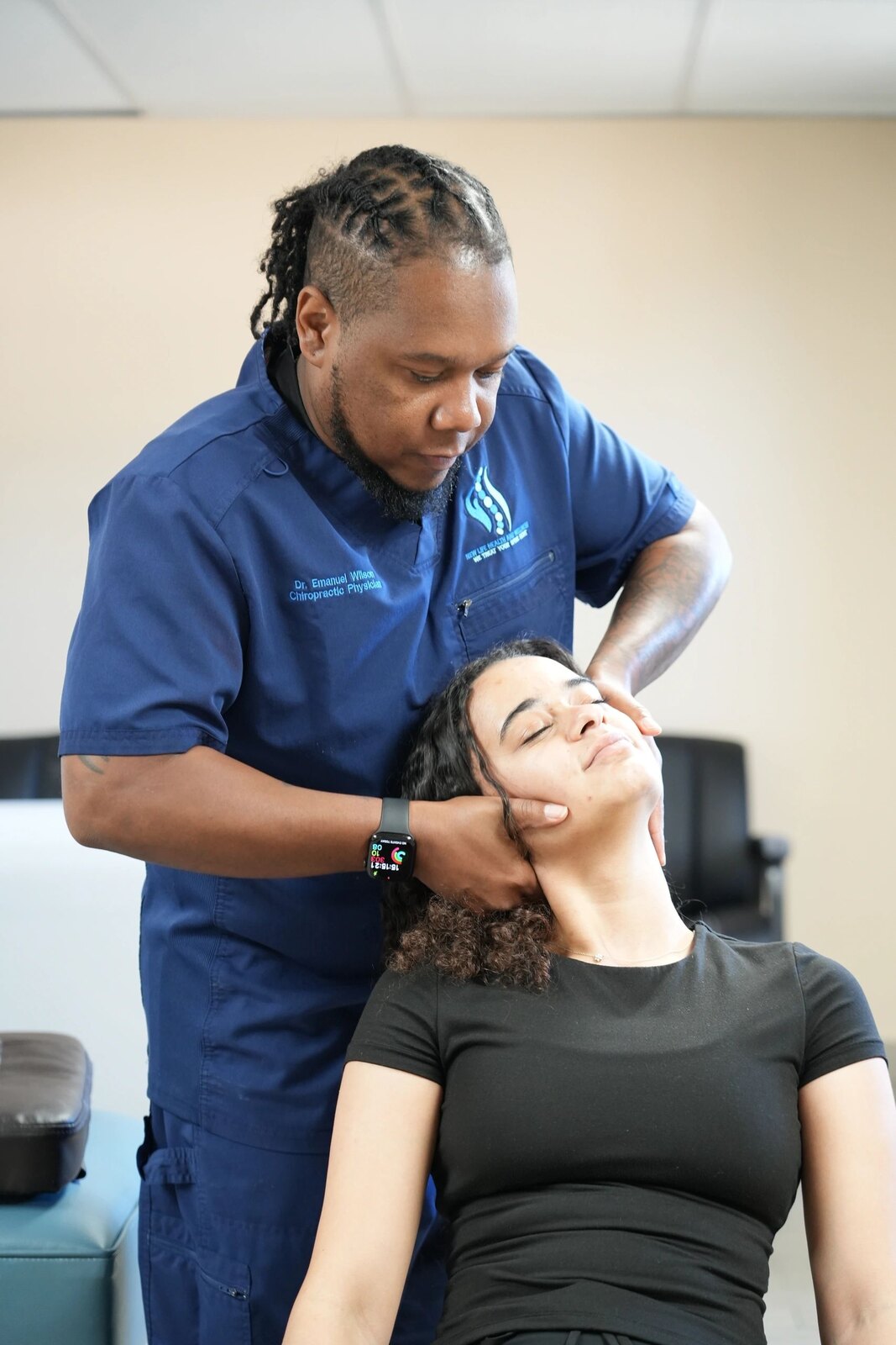 Dr. Emanuel Wilson providing chiropractic care to a patient in Jacksonville